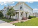 Charming two-story home with manicured lawn and inviting front porch at 6251 Camino Dr, Apollo Beach, FL 33572