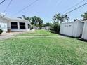 Spacious backyard featuring lush green grass and storage sheds perfect for outdoor activities at 6398 17Th N Pl, St Petersburg, FL 33710