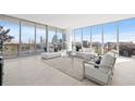 Bright living room with floor-to-ceiling windows offering stunning city views, and contemporary furnishings at 777 3Rd N Ave # 805, St Petersburg, FL 33701