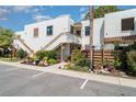 Condo complex with white stucco, wood trim, stairway access, landscaped gardens, and well-maintained grounds at 127 Tidewater Dr # 127, Bradenton, FL 34210