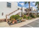 Well-maintained condo complex with white stucco, wood accents, lush landscaping, and convenient parking at 127 Tidewater Dr # 127, Bradenton, FL 34210