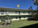 Condo exterior showing a second-story balcony with a view of the well-maintained green lawn at 128 Nancy Dr # 128, Oldsmar, FL 34677