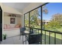 Relaxing screened patio with comfortable seating and a view of the yard at 128 Nancy Dr # 128, Oldsmar, FL 34677