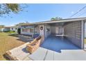 Inviting home featuring a carport, stylish brick accents, and a neat front lawn at 1520 S Richard Ave, Tampa, FL 33629