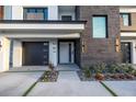 Contemporary home featuring a modern garage door, decorative stone accents and walkway at 201 Punta Vista Dr, St Pete Beach, FL 33706