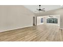Bright living room features vaulted ceilings, light hardwood floors and neutral paint at 2224 Vista Royal Way, Spring Hill, FL 34606