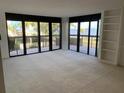 Bright living room with plush carpeting and a sliding glass door leading to a balcony with water views at 2413 Bayshore Blvd # 205, Tampa, FL 33629