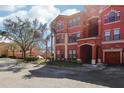 Stylish red condo complex with attached garages and beautiful surrounding greenery at 2713 Via Murano # 216, Clearwater, FL 33764