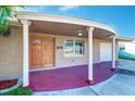 Inviting front entrance with detailed woodwork and a covered porch with support columns at 3048 Holiday Lake Dr, Holiday, FL 34691