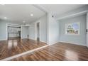 Bright and airy living room featuring sleek wood floors and freshly painted walls, seamlessly connecting to the kitchen at 3620 E Shadowlawn Ave, Tampa, FL 33610