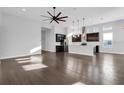 Open-concept living space with hardwood floors seamlessly connects the living area and gourmet kitchen at 5943 Jasper Glen Dr, Lithia, FL 33547