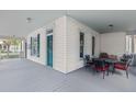 Corner porch featuring neutral paint and an outdoor dining set perfect for relaxing or entertaining at 709 W Azeele St, Tampa, FL 33606