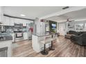 Open kitchen with island seating, stainless appliances, and seamless access to the living area at 7402 Sherren Dr, Tampa, FL 33619