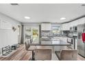 Bright kitchen with white cabinets, stainless steel appliances, and a large kitchen island at 7402 Sherren Dr, Tampa, FL 33619