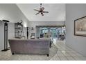 Bright living room features high ceilings, tile floors, and is decorated with modern furniture at 8045 Sugarbush Dr, Spring Hill, FL 34606