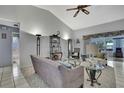 Bright living room features high ceilings, tile floors, and is decorated with modern furniture at 8045 Sugarbush Dr, Spring Hill, FL 34606