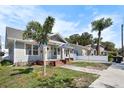 Charming single-Gathering home with quaint front porch, brick steps, palm trees, and well-kept front yard at 951 9Th S Ave, St Petersburg, FL 33705