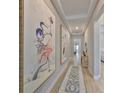 Elegant hallway with hardwood floors, tray ceilings, and decorative paintings at 1009 Seagrape Dr, Ruskin, FL 33570