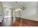 Bright, spacious living room with hardwood floors, large windows, and sliding doors to a screened-in patio at 10614 Chambers Dr, Tampa, FL 33626