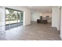 Sun-filled open-concept living space featuring hardwood floors and access to the backyard at 14184 Hammock Crest Way, Riverview, FL 33569