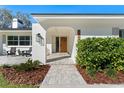 Welcoming front entrance with a paved walkway, manicured bushes, and a stylish front door at 1664 Sharon Way, Clearwater, FL 33764