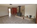 Spacious living room featuring a unique brick fireplace and tile flooring at 18855 Dvorak Dr, Spring Hill, FL 34610