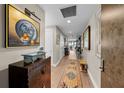 Hallway with hardwood floors, art, table and a decorative runner rug at 199 Dali Blvd # 807, St Petersburg, FL 33701