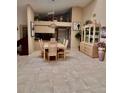 Well-lit dining area with tile flooring, a modern chandelier, and ample space for entertaining at 2439 Hidden Trail Dr, Spring Hill, FL 34606