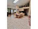 Open dining room featuring a skylight, a modern chandelier, and seamless flow to the living area at 2439 Hidden Trail Dr, Spring Hill, FL 34606