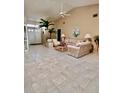 Spacious living room featuring high ceilings, tile flooring, and a cozy seating area at 2439 Hidden Trail Dr, Spring Hill, FL 34606