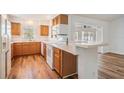 Traditional kitchen with wood cabinets, sleek countertops, and a convenient breakfast bar at 29443 Zeller Ave, San Antonio, FL 33576