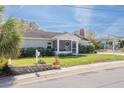 Charming home with a well-manicured lawn and a cozy, screened-in front porch, perfect for enjoying the outdoors at 305 6Th Sw Ave, Largo, FL 33770