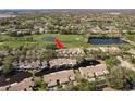 Scenic aerial view of townhomes near a golf course and community ponds at 3130 Eagles Landing W Cir, Clearwater, FL 33761