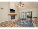 Inviting living room with a brick fireplace, wood floors, and sliding doors at 3130 Eagles Landing W Cir, Clearwater, FL 33761