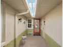 Inviting entryway with a decorative glass door, sidelight window, and overhead lighting at 335 Stroll Ln, Sun City Center, FL 33573