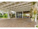 Beautiful building entrance with brick pavers, an intricate awning, and tropical landscaping at 400 Island Way # 612, Clearwater Beach, FL 33767