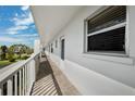 Condo balcony featuring pristine white walls, and an exterior view of the community at 4240 Ironwood Cir # 404, Bradenton, FL 34209