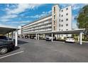 Exterior view of the condo building featuring covered resident parking at 4240 Ironwood Cir # 404, Bradenton, FL 34209