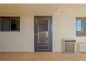 Condo entrance door to unit 307 with an air conditioning unit nearby at 5915 Sea Ranch Dr # 307, Hudson, FL 34667