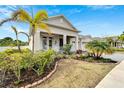 Well-maintained home featuring a cozy front porch, manicured landscaping, and a lush lawn at 618 Manns Harbor Dr, Apollo Beach, FL 33572