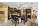 Elegant kitchen featuring a large island with seating, dark cabinetry, and modern appliances at 8414 Eagle Brook Dr, Land O Lakes, FL 34638
