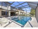 Beautiful screened pool area with a hot tub and plenty of seating for outdoor enjoyment at 8414 Eagle Brook Dr, Land O Lakes, FL 34638