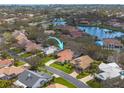 Aerial view of a neighborhood with mature landscaping and a community lake at 872 Live Oak Ne Ter, St Petersburg, FL 33703