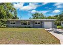Charming single-story home with a well-maintained lawn and a large driveway at 1119 77Th N St, St Petersburg, FL 33710