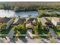 Aerial view of a tan single-Gathering home with a view of a body of water and neighboring houses at 11720 Winterset Cove Dr, Riverview, FL 33579