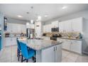 Bright kitchen featuring white cabinets, granite countertops, and a large center island at 1516 Glen Alpine Pl, Valrico, FL 33594