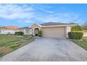 Attractive one-story home with an attached two-car garage and a neatly maintained lawn at 1559 Overland Dr, Spring Hill, FL 34608