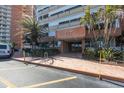 Inviting entrance to building with beautiful landscaping and brick paved drive at 17920 Gulf Blvd # 1103, Redington Shores, FL 33708