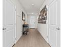 Inviting hallway with wood-look tile flooring and stylish decor at 3224 Fresno Pl, Zephyrhills, FL 33541