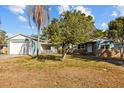 Charming single Gathering home featuring brick facade, tidy lawn, mature trees, and a detached garage in the front yard at 3235 34Th N Ave, St Petersburg, FL 33713